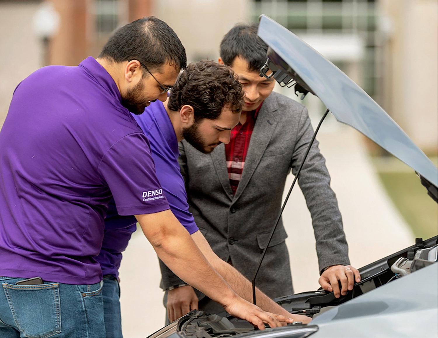 From left: Brandon Patel and Maxavier Lamantia, graduate research assistants, and Pingen Chen, Ph.D., associate professor of mechanical engineering, inspect a Nissan Leaf – one of two electric vehicles made in Tennessee.